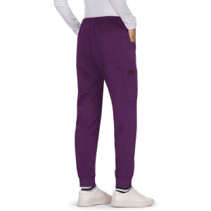 A pair of purple Aster Pants with an elastic waistband and side pockets, worn with white shoes.