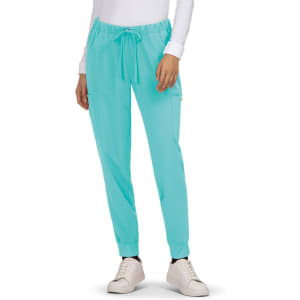 Turquoise jogger pants with a drawstring waist and side pockets, paired with white sneakers.