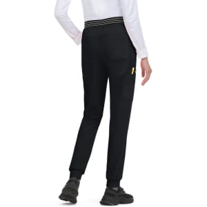 A pair of black jogger pants with a fitted cuff and a visible logo on the side, worn with a white top.