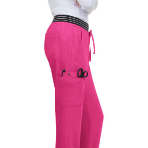 A pink jogger with pockets, featuring scissors and a striped waistband. The design is casual and functional.