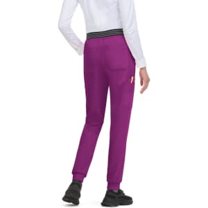 A pair of purple joggers with a black striped waistband and pockets, worn by a person from the back.