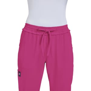 A pair of bright pink pants with an elastic waistband and drawstring, featuring a small logo.