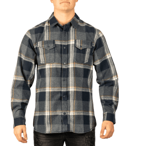 A man wearing a blue and grey checked short sleeve yarn-dyed flannel snap shirt with two chest pockets.