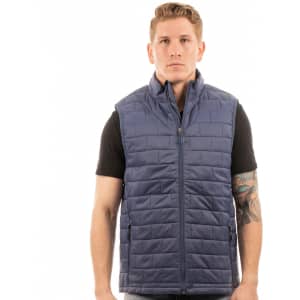 A navy blue puffer vest is displayed on a model, showcasing its side view and sleek design. Features a logo.
