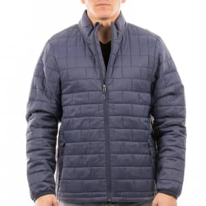 A man wearing a navy blue puffer jacket with a zip front and side pockets, featuring a logo on the chest.
