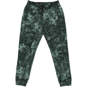 Tech fleece knit jogger pants in a green tie-dye pattern, featuring side pockets and an elastic waistband.