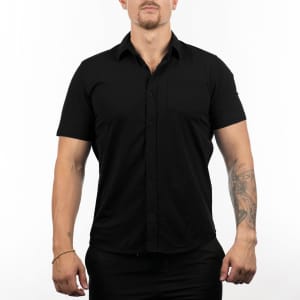 A black short sleeve shirt featuring a button-up design and a small pocket, with a brand logo on the sleeve.
