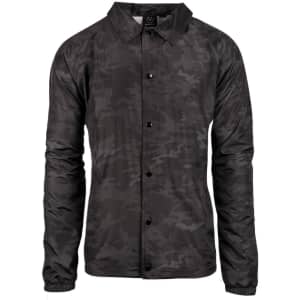 A black camouflage coaches jacket with long sleeves and a button-up front, featuring a logo on the collar.