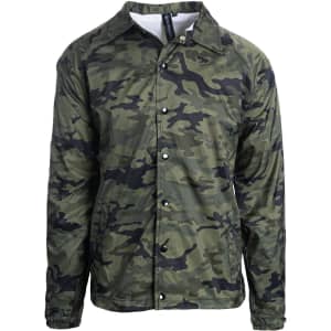 A camouflage coaches jacket in shades of green, featuring a button-up front and a collar. It includes a logo.