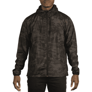 A lightweight windbreaker in a dark camouflage pattern, featuring a hood and zippers, displayed on a model.