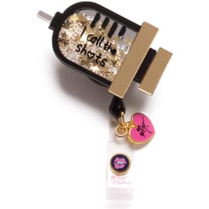 A retractable badge holder featuring black and gold accents with glitter and a charm shaped like a lip gloss bottle.