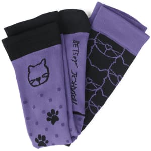 A set of three purple compression socks featuring black patterns, including animal prints and line designs.