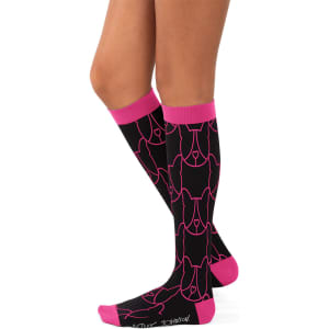 A pair of black compression socks featuring a pink pattern and cuffs, displayed on a model's legs.