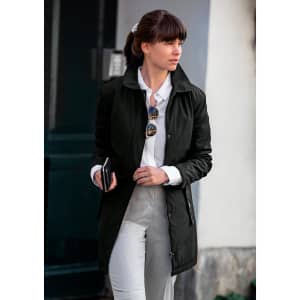 A stylish black women's jacket is featured, worn over a white shirt and grey pants, accessorised with sunglasses.