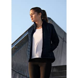 A soft shell jacket in navy, worn by a woman, features a zip front and a sleek design. It has branding on it.