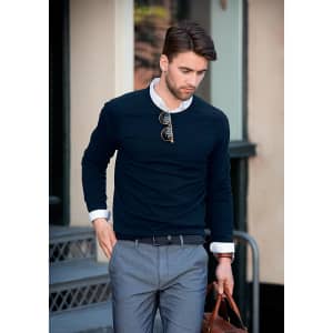A navy Brighton O-Neck men's knit jumper with a white collared shirt underneath, paired with grey trousers and accessories.