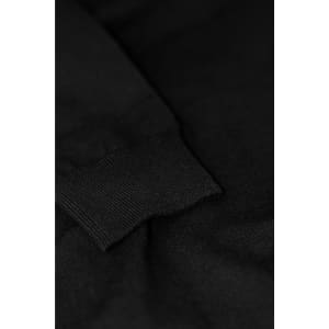 A close-up of a black Brighton Cardigan featuring a ribbed cuff detail. The fabric appears soft and textured.