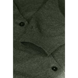A green cardigan featuring a knit texture and button details, highlighting the sleeve and cuff.