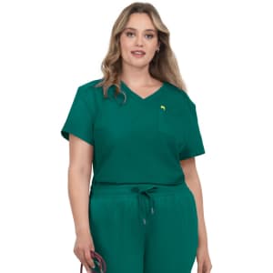 A short-sleeved, v-neck scrub top in teal with a chest pocket and a small logo, styled on a model.