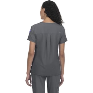 A grey medical scrub top with a back pleat, featuring a logo on the sleeve.