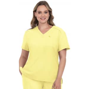 A medical scrub top in bright yellow with a V-neck and a pocket, featuring a small logo.