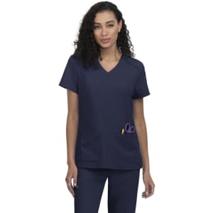 A navy blue scrub top featuring a V-neck design and a pocket with scissors. The model has curly hair.