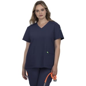 A navy blue medical scrub top with a V-neck and two front pockets, featuring a logo on the sleeve.