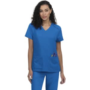 A blue medical scrub top with a v-neck design and two front pockets. The model is wearing matching blue pants.