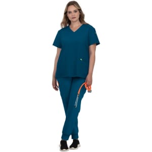 A teal-coloured scrub set featuring a V-neck top and straight-leg pants, worn by a model holding a stethoscope.