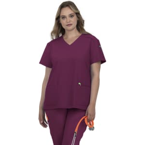 A scrub top in purple, featuring short sleeves and a V-neck, paired with matching pants and a stethoscope.