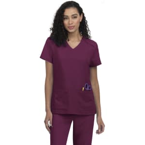 A medical scrub top in a deep plum colour, featuring two front pockets and a v-neck design.