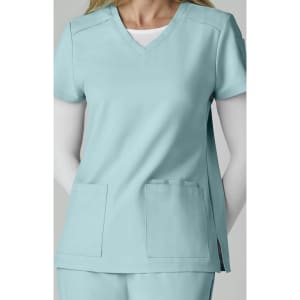 A scrub top in light blue, featuring a V-neck, short sleeves, and two front pockets. It has a logo on the sleeve.