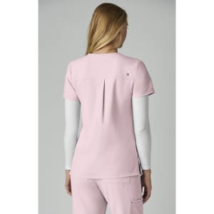 A pink top with short sleeves and a back pleat, featuring a logo on the back.