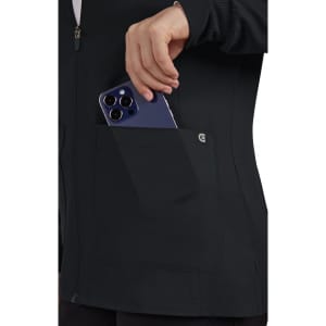 A black women's jacket featuring a side pocket with a smartphone being placed inside. It has a branding logo.