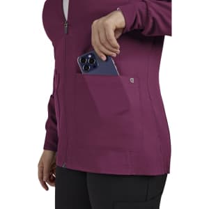 A women's jacket in maroon with a zip front and pocket, featuring a smartphone being placed inside.