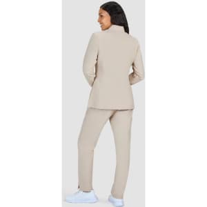 A beige women's jacket with matching pants, featuring a high collar and a simple design.