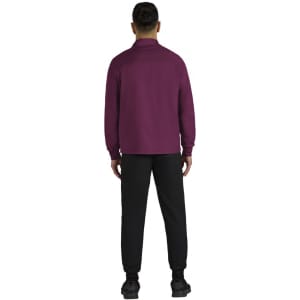 A maroon jacket with long sleeves, worn by a person facing away, paired with black trousers. Features a logo on the jacket.