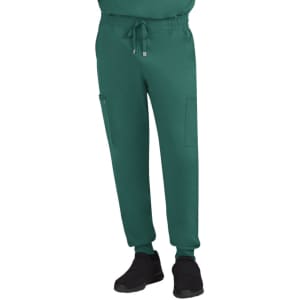 A pair of green joggers with pockets, featuring a drawstring waist and elastic cuffs, worn with black shoes.