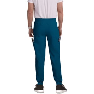 A pair of teal joggers with pockets, worn by a person from the back, featuring an elastic waistband.