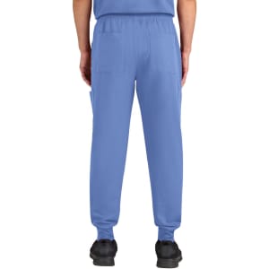 A pair of blue jogger pants with an elastic waistband and back pockets. The image features a model from the back.
