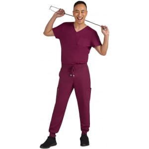 A man wearing a burgundy jogger outfit, featuring a short-sleeve top and tapered pants with pockets, holding a utensil.