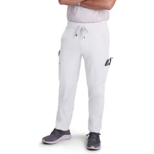A pair of white cargo pants with multiple pockets, worn by a person standing with arms crossed.