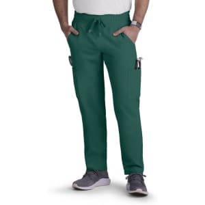 A pair of dark green cargo pants with a drawstring waist and pockets, worn by a person standing with hands in the pockets.