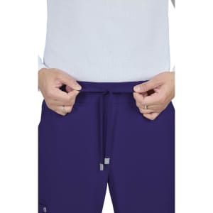 A pair of purple cargo pants with drawstrings at the waist, held by a person with hands.