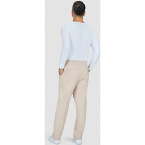 A person stands facing away wearing beige cargo pants and a fitted white long-sleeve top. The pants have pockets and a logo.
