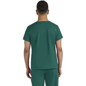 A scrub top in a teal colour, featuring a simple design and a logo on the back.