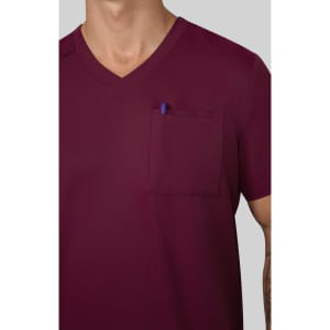 A burgundy V-neck shirt featuring a chest pocket with a pen inserted. The fabric appears smooth and solid.