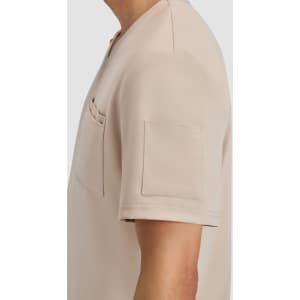 A short-sleeved beige top featuring a pocket and a patch pocket on the sleeve, with a smooth fabric finish.