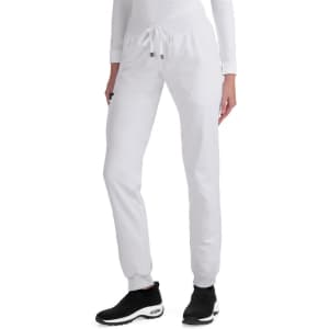 A pair of white jogger pants with a drawstring waist, styled with black athletic shoes.