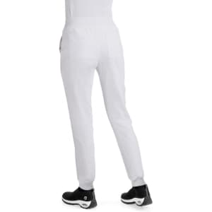 A pair of white jogger pants with pockets, worn with black athletic shoes. The view is from the back.